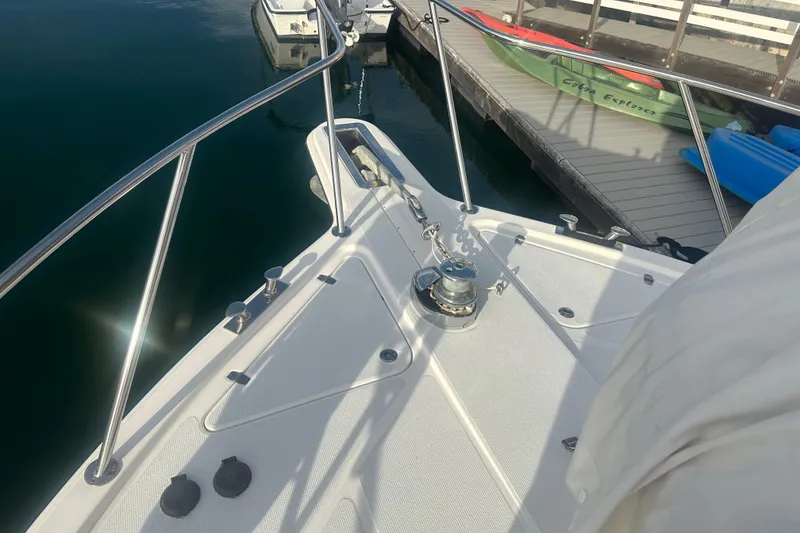 Slide: The Image of 2007 Riviera Sport Fisherman boat deck with railing and docked kayaks. - 32