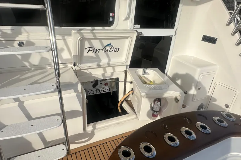 Slide: The Image of 2007 Riviera Sport Fisherman boat deck with sink, storage, and ladder. - 35