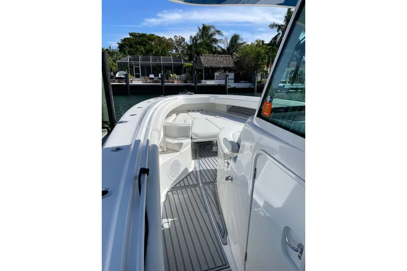 Slide: The Image of 2019 HCB 42 Siesta boat with sleek white deck and seating area. - 17