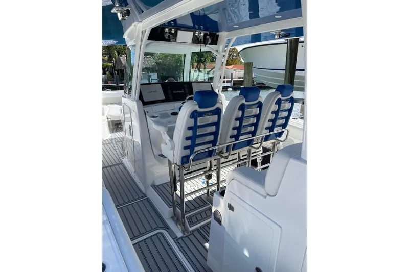 Slide: The Image of 2019 HCB 42 Siesta boat interior with blue and white seating and navigation equipment. - 22