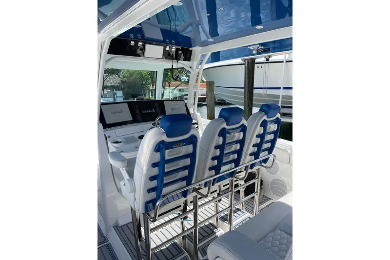 Slide: The Image of Interior of 2019 HCB 42 Siesta boat with blue and white seating and Garmin displays. - 23