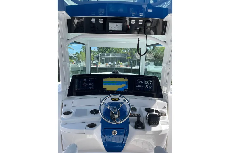 Slide: The Image of 2019 HCB 42 Siesta boat helm with advanced navigation displays and controls. - 25