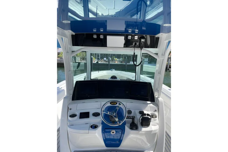 Slide: The Image of 2019 HCB 42 Siesta boat helm with modern controls and blue accents. - 26