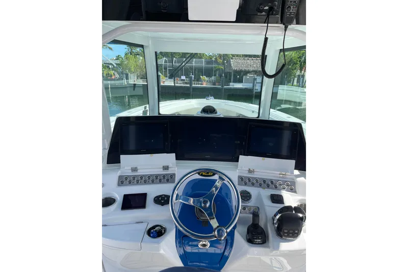 Slide: The Image of Helm of 2019 HCB 42 Siesta boat with modern controls and navigation screens. - 27