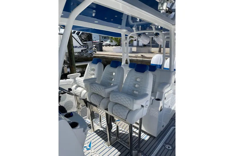 Slide: The Image of 2019 HCB 42 Siesta boat interior with luxurious white seating and blue accents. - 28