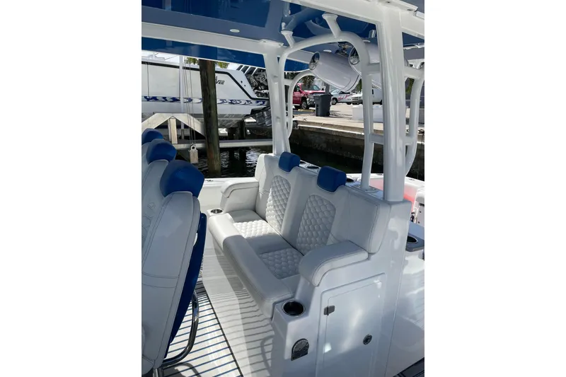 Slide: The Image of 2019 HCB 42 Siesta boat interior with white and blue seating. - 29