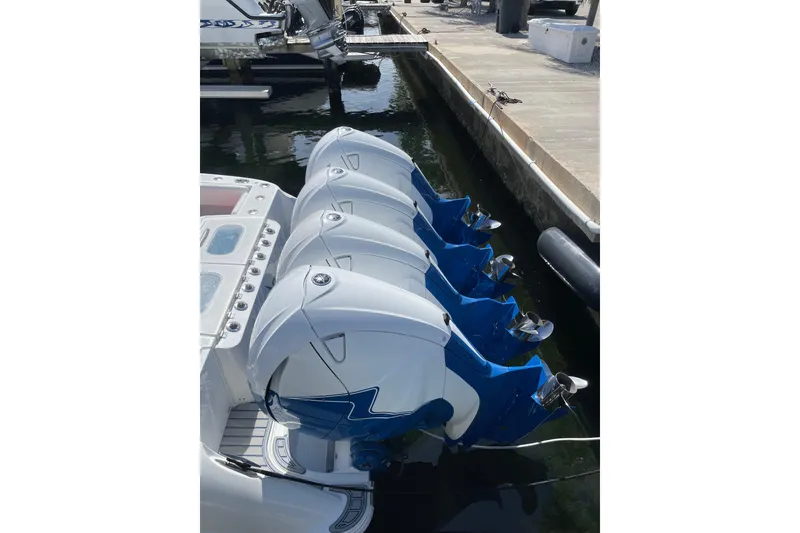 Slide: The Image of 2019 HCB 42 Siesta boat docked with triple outboard engines. - 3