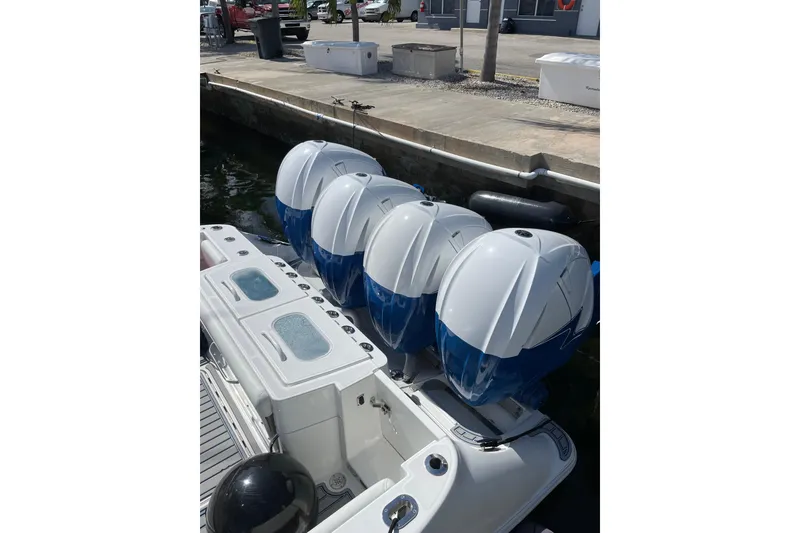 Slide: The Image of 2019 HCB 42 Siesta boat with four powerful outboard engines docked. - 4