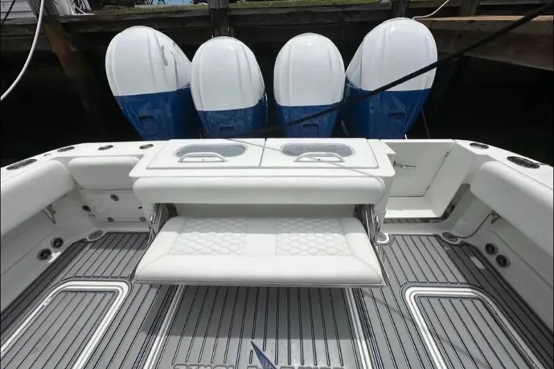 Slide: The Image of 2019 HCB 42 Siesta boat with four powerful outboard engines docked at marina. - 5