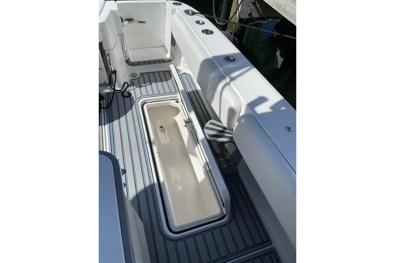 Slide: The Image of 2019 HCB 42 Siesta boat with four outboard engines and spacious deck seating. - 6