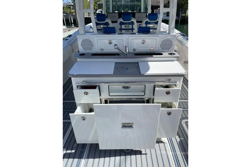 Slide: The Image of 2019 HCB 42 Siesta boat with sleek white interior and fishing rod holders. - 8