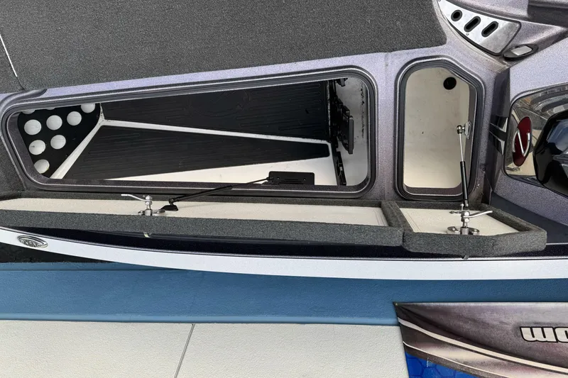 Slide: The Image of 2016 Ranger Z521 Comanche boat storage compartments open, showcasing interior design. - 12