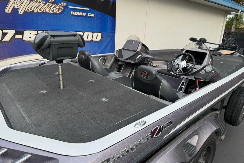 Slide: The Image of 2016 Ranger Z521 Comanche boat with spacious deck and modern cockpit controls. - 4