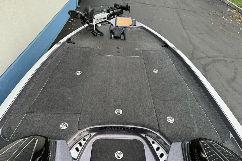 Slide: The Image of 2016 Ranger Z521 Comanche boat deck with trolling motor, parked on pavement. - 6