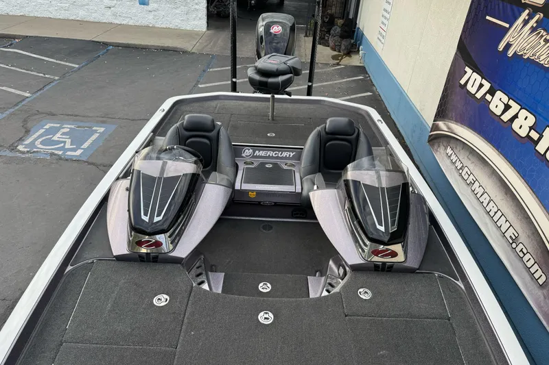 Slide: The Image of 2016 Ranger Z521 Comanche boat with Mercury engine, parked near a marine shop. - 8