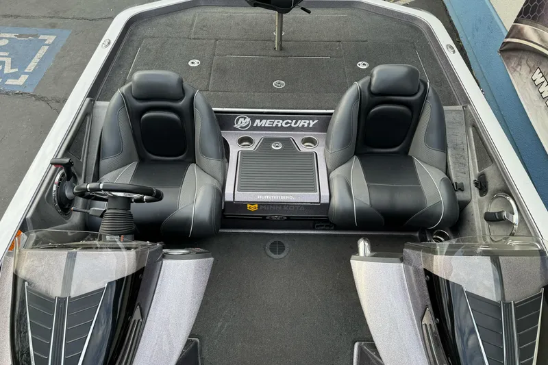 Slide: The Image of 2016 Ranger Z521 Comanche boat interior with dual seats and Mercury branding. - 9