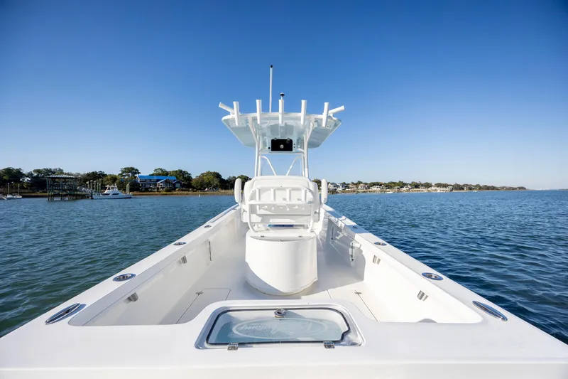 Slide: The Image of 2023 Pair Customs 24 Center Console DV boat on calm water, clear sky. - 10