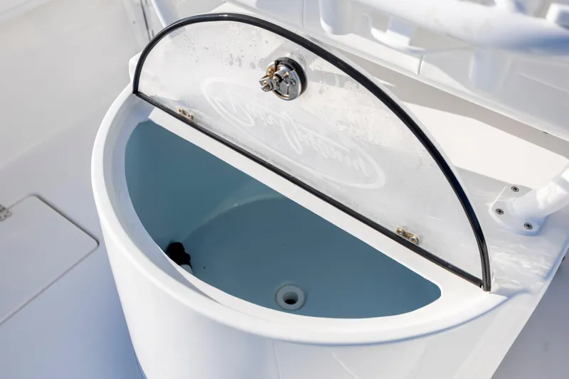Slide: The Image of Open storage compartment on 2023 Pair Customs 24 Center Console DV boat. - 12