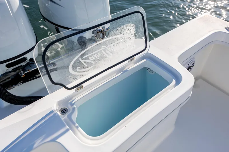 Slide: The Image of Open storage compartment on 2023 Pair Customs 24 Center Console DV boat. - 13