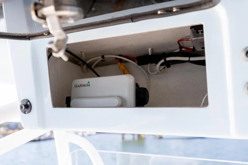 Slide: The Image of 2023 Pair Customs 24 Center Console DV with Garmin equipment in storage compartment. - 14