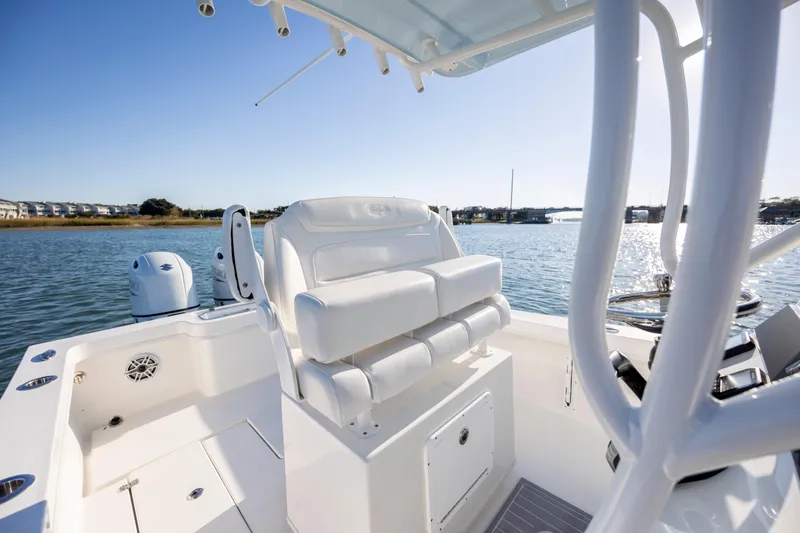 Slide: The Image of 2023 Pair Customs 24 Center Console DV boat interior on calm water. - 15