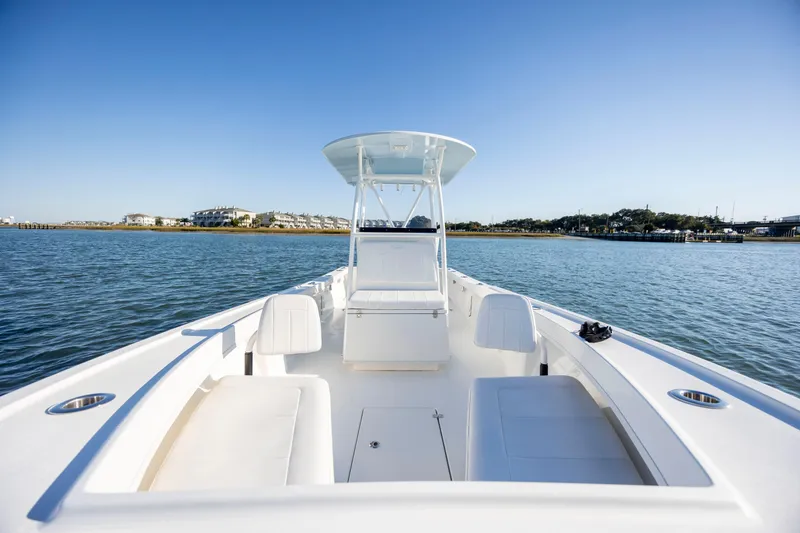 Slide: The Image of 2023 Pair Customs 24 Center Console DV boat on calm water, clear sky. - 18