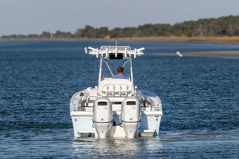 Slide: The Image of 2023 Pair Customs 24 Center Console DV boat cruising on open water. - 3