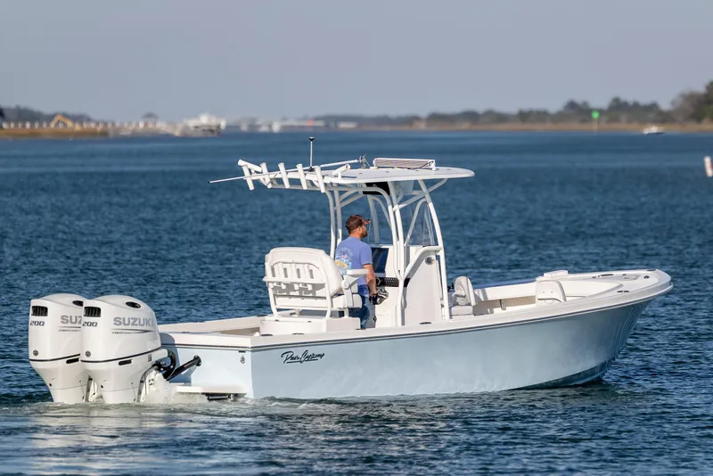 Slide: The Image of 2023 Pair Customs 24 Center Console DV boat cruising on open water. - 4