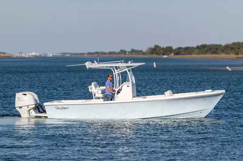 Slide: The Image of 2023 Pair Customs 24 Center Console DV boat cruising on a calm waterway. - 5