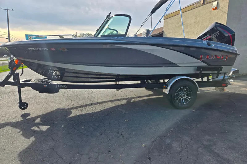 Slide: The Image of 2020 Lund 189 Tyee GL boat on trailer, parked outdoors, side view. - 18