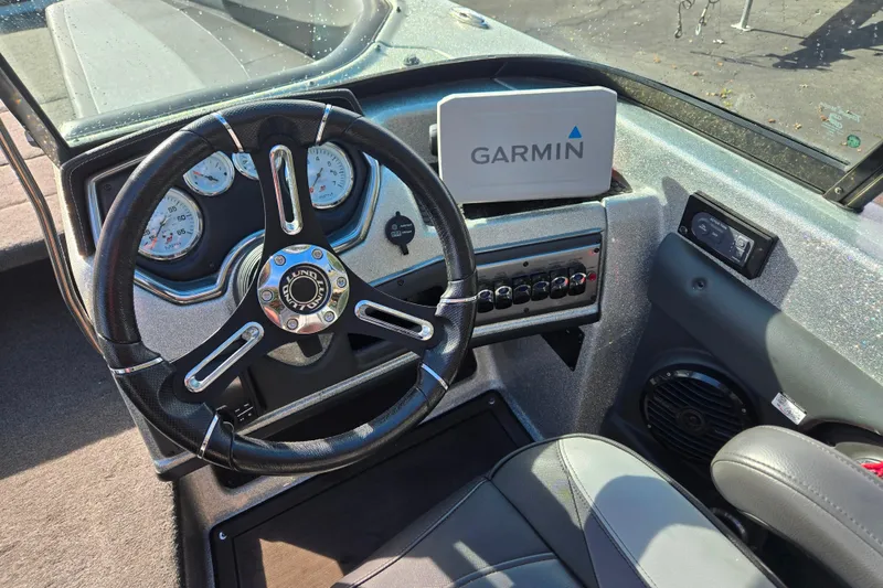 Slide: The Image of 2020 Lund 189 Tyee GL boat dashboard with Garmin navigation system and steering wheel. - 21