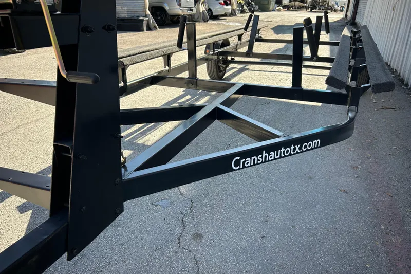 Slide: The Image of 2018 Sun Tracker Party Barge 18 DLX pontoon boat on trailer by the water. - 10