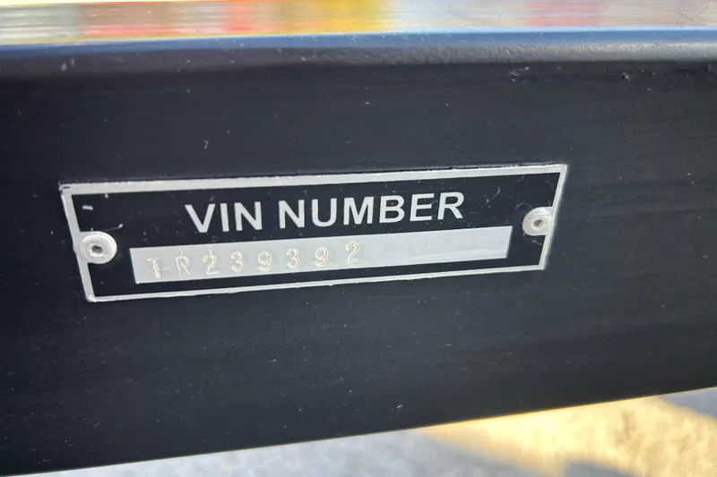 Slide: The Image of 2018 Sun Tracker Party Barge 18 DLX pontoon boat in a warehouse setting. - 12