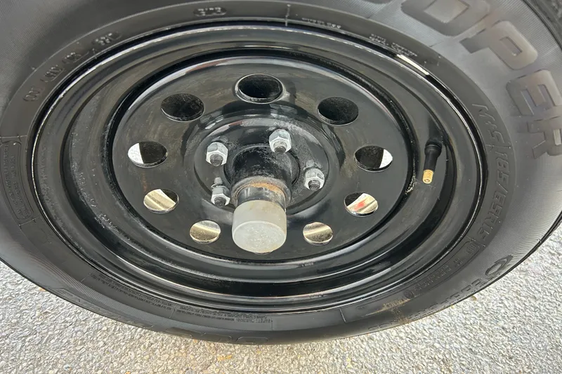 Slide: The Image of 2018 Sun Tracker Party Barge 18 DLX logo on boat exterior. - 16