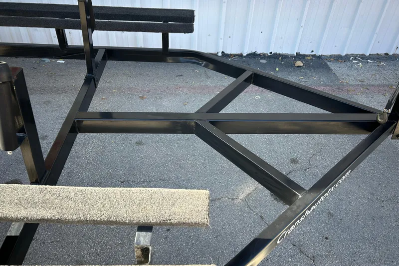 Slide: The Image of 2018 Sun Tracker Party Barge 18 DLX pontoon boat in a warehouse setting. - 17