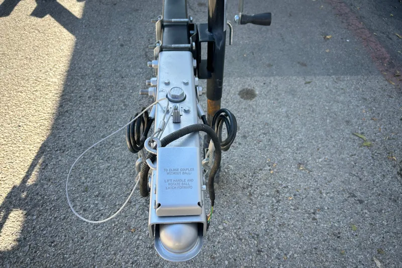 Slide: The Image of 2018 Sun Tracker Party Barge 18 DLX with Mercury FourStroke engine in a covered storage area. - 18