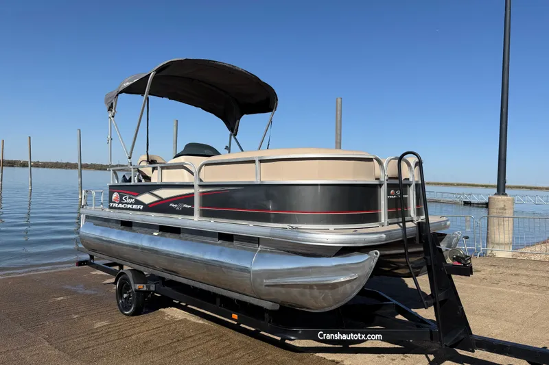 Slide: The Image of 2018 Sun Tracker Party Barge 18 DLX seat storage compartment, beige upholstery. - 26