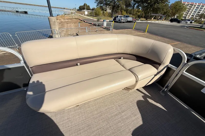 Slide: The Image of 2018 Sun Tracker Party Barge 18 DLX storage compartment with beige seating. - 31