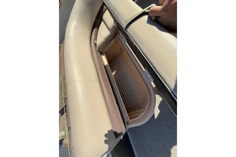 Slide: The Image of 2018 Sun Tracker Party Barge 18 DLX pontoon boat with beige seating at a lakeside dock. - 32