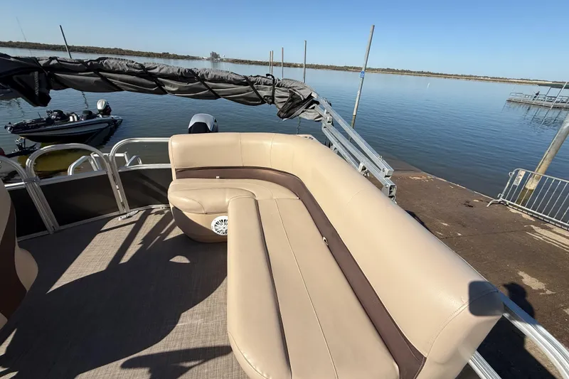 Slide: The Image of 2018 Sun Tracker Party Barge 18 DLX storage compartment with beige upholstery. - 34