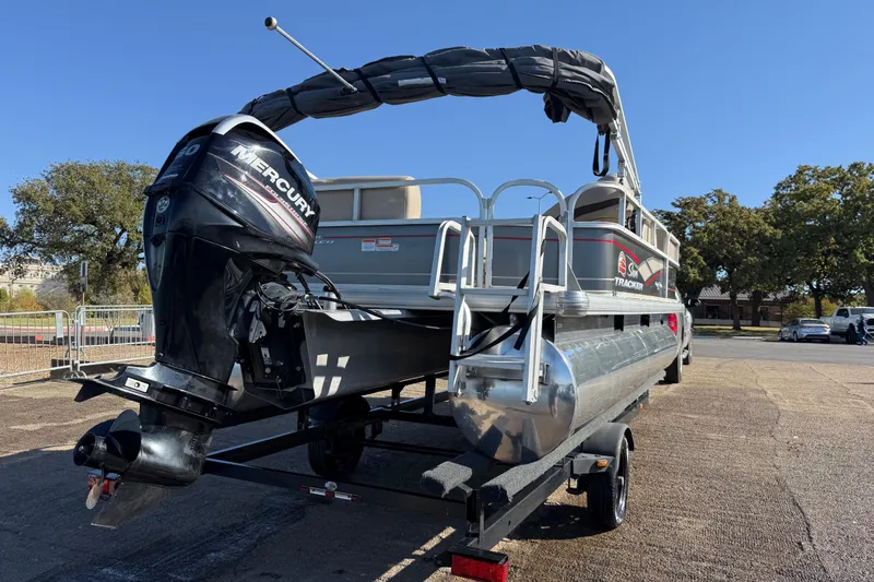 Slide: The Image of 2018 Sun Tracker Party Barge 18 DLX pontoon boat on trailer by a lake. - 49
