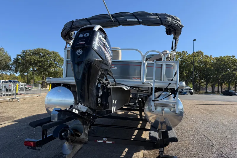Slide: The Image of 2018 Sun Tracker Party Barge 18 DLX pontoon boat docked by a serene lake. - 50