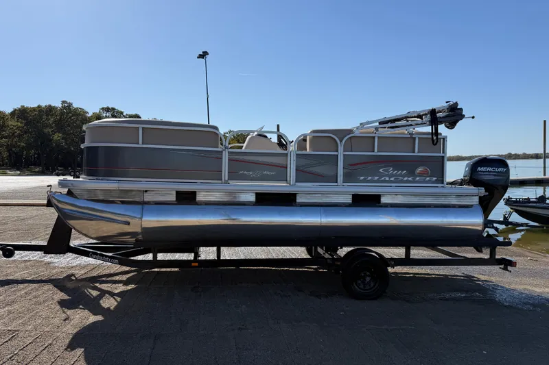 Slide: The Image of 2018 Sun Tracker Party Barge 18 DLX pontoon boat on a serene lake. - 57