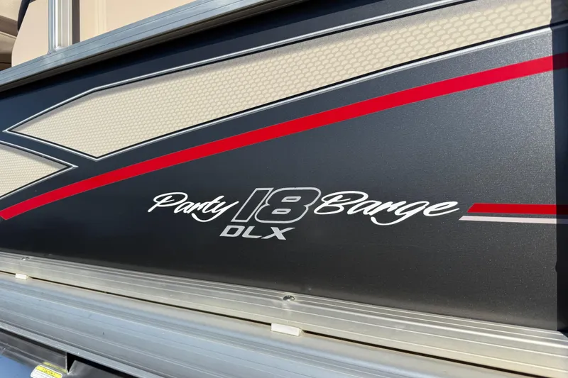 Slide: The Image of 2018 Sun Tracker Party Barge 18 DLX trailer, parked outdoors on concrete. - 64