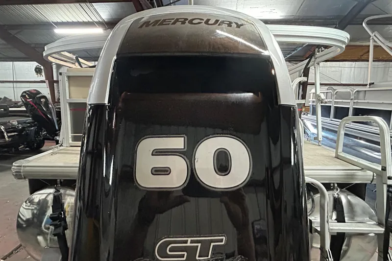 Slide: The Image of 2018 Sun Tracker Party Barge 18 DLX pontoon boat on trailer by the water. - 8