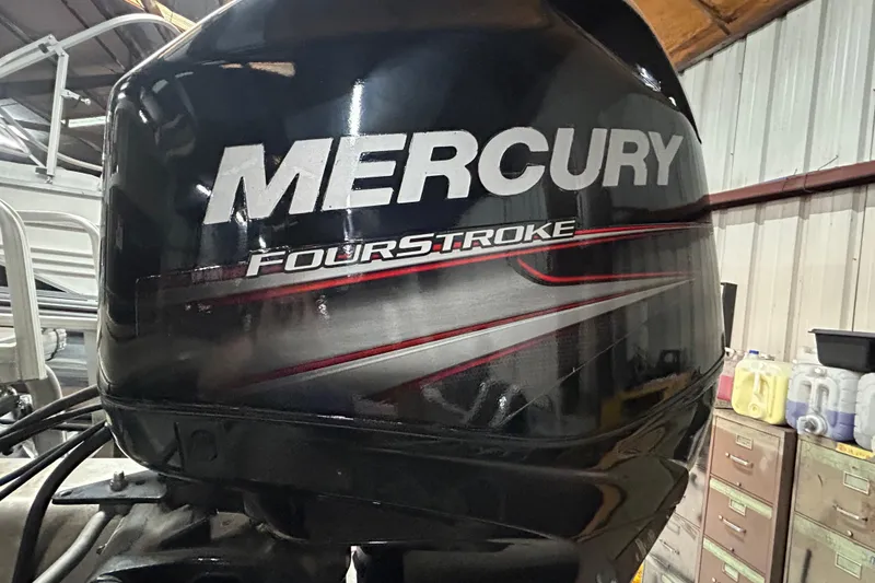 Slide: The Image of 2018 Sun Tracker Party Barge 18 DLX pontoon boat on trailer by the water. - 9