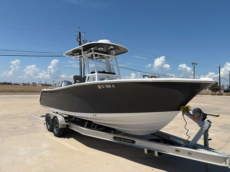 Slide: The Image of 2021 Sportsman Heritage 241 Center Console boat on trailer under clear sky. - 6