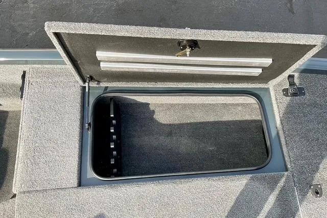 Slide: The Image of 2023 Ranger RT198P boat storage compartment with open lid, showcasing interior space. - 10