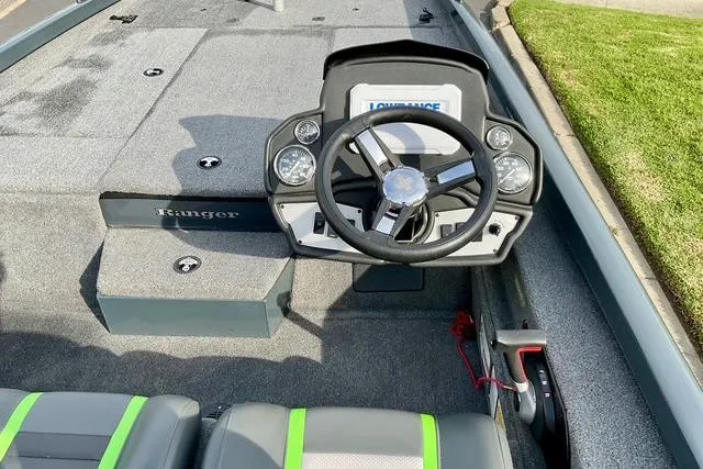 Slide: The Image of 2023 Ranger RT198P boat cockpit with steering wheel and Lowrance display. - 17