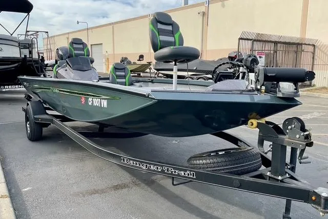 Slide: The Image of 2023 Ranger RT198P fishing boat on trailer, parked outdoors. - 18